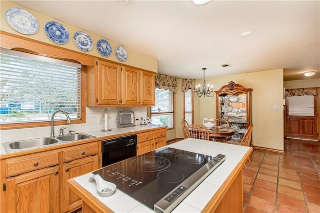 kitchen featuring black appliances, plenty of natural light, and tile countertops