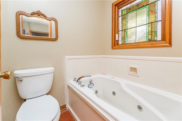 bathroom with a washtub and toilet