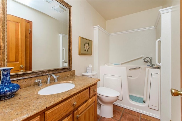 bathroom featuring vanity, toilet, and a tub