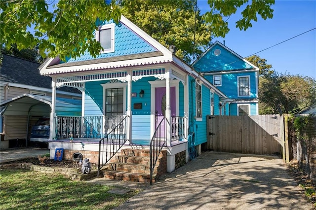 view of front of house with covered porch and a carport