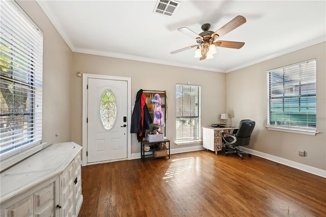 entrance foyer with ceiling fan, dark wood-type flooring, and ornamental molding