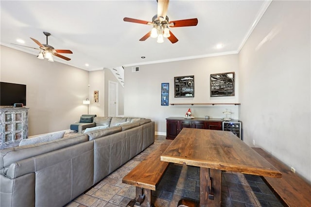 living room with ceiling fan and ornamental molding