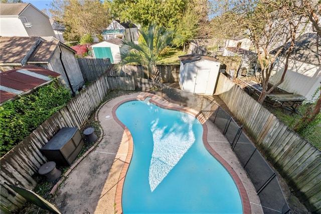 view of swimming pool featuring a storage shed