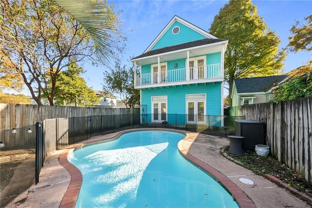 419 Romain St, Gretna, LA 70053 - rear view of house featuring french doors, a fenced backyard, and a balcony