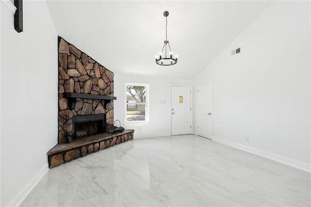 living room featuring a stone fireplace, lofted ceiling, and a notable chandelier