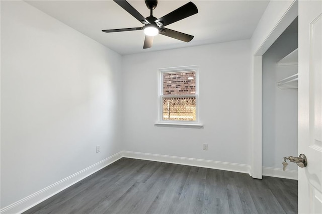 unfurnished bedroom with a closet, dark hardwood / wood-style floors, and ceiling fan