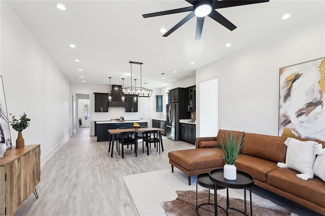 living room featuring light wood-type flooring and ceiling fan