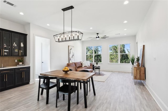 dining space with ceiling fan and light hardwood / wood-style floors