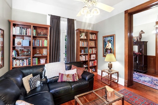 living room featuring wood-type flooring and ceiling fan