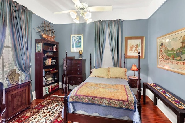 bedroom with ceiling fan and dark hardwood / wood-style flooring