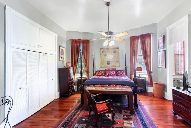 bedroom with ceiling fan, dark hardwood / wood-style flooring, and a closet