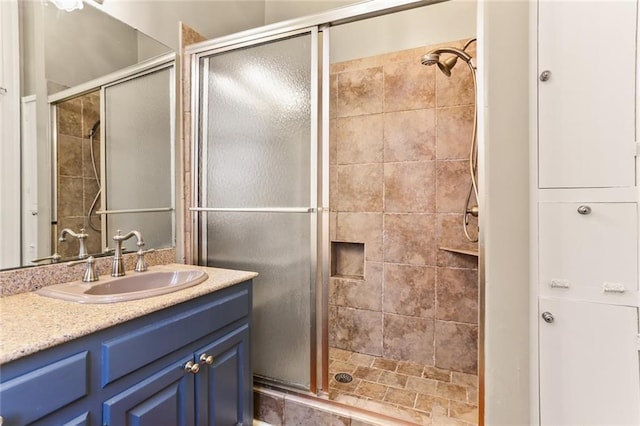 bathroom featuring vanity and a shower stall