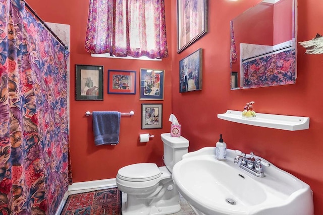 bathroom featuring tile patterned floors, toilet, and sink