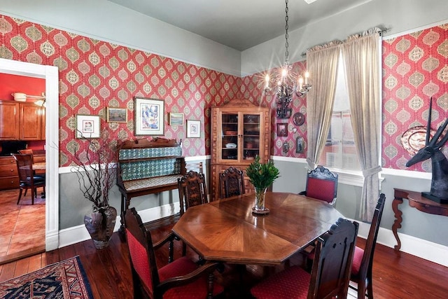 dining area featuring dark hardwood / wood-style flooring and a notable chandelier