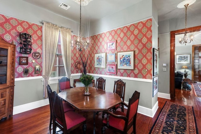 dining room with a chandelier and dark wood-type flooring