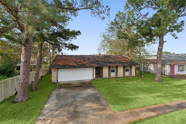 single story home with a garage and a front lawn