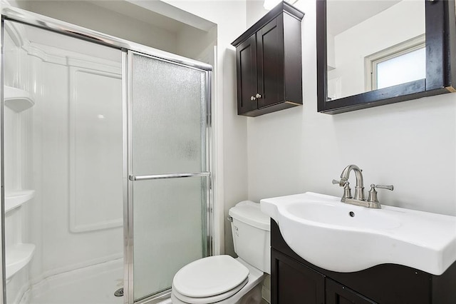 bathroom featuring walk in shower, vanity, and toilet