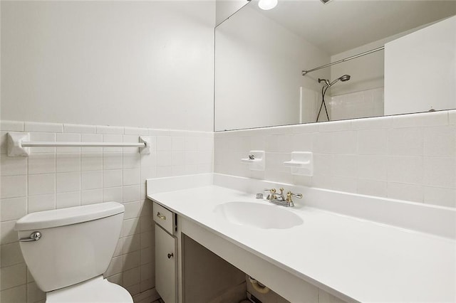 bathroom featuring vanity, toilet, and tile walls