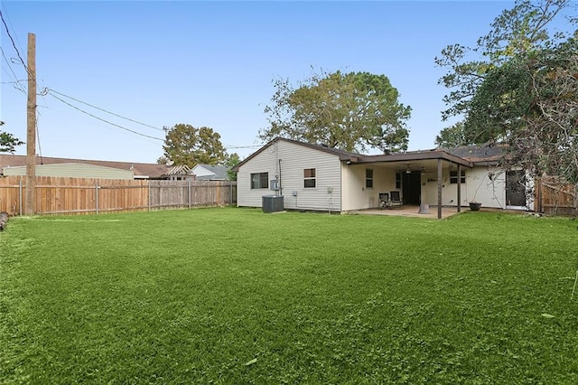 back of house with a yard and a patio