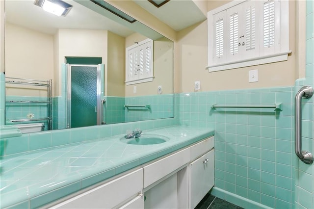 bathroom with vanity and tile walls