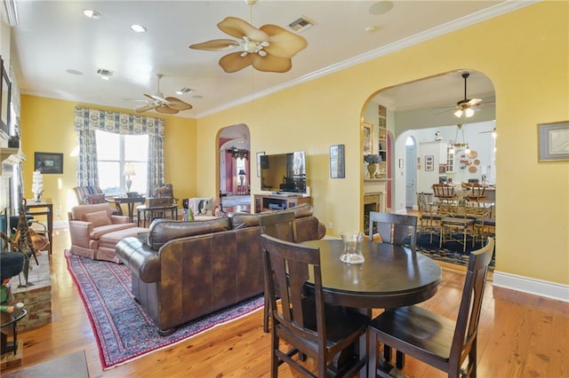 dining area with ceiling fan, light hardwood / wood-style floors, and crown molding