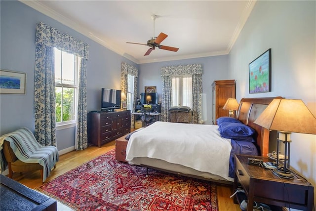 bedroom with light hardwood / wood-style floors, multiple windows, and ceiling fan