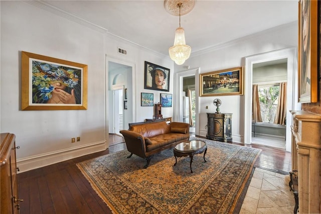 sitting room with hardwood / wood-style floors and crown molding