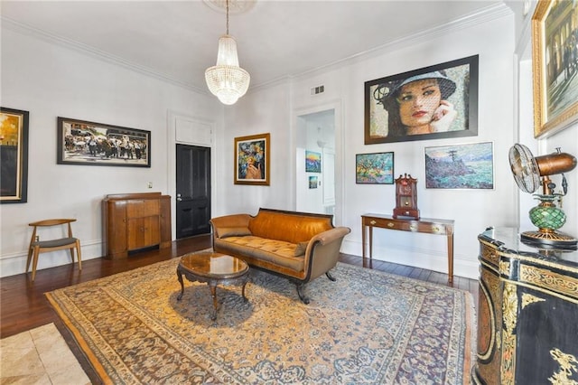 living area featuring ornamental molding, wood-type flooring, and an inviting chandelier