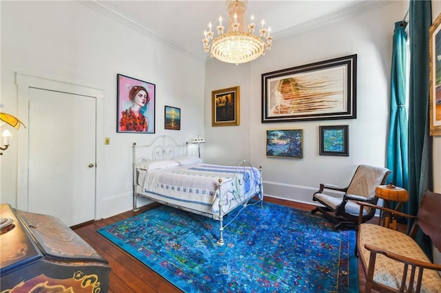 bedroom featuring ornamental molding, a notable chandelier, and dark hardwood / wood-style flooring