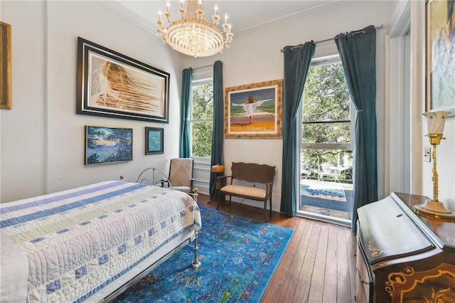 bedroom featuring multiple windows, crown molding, hardwood / wood-style flooring, and a notable chandelier