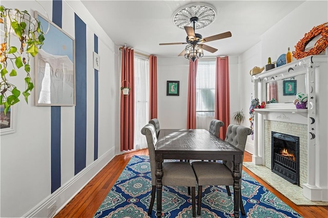 dining area with hardwood / wood-style floors and ceiling fan