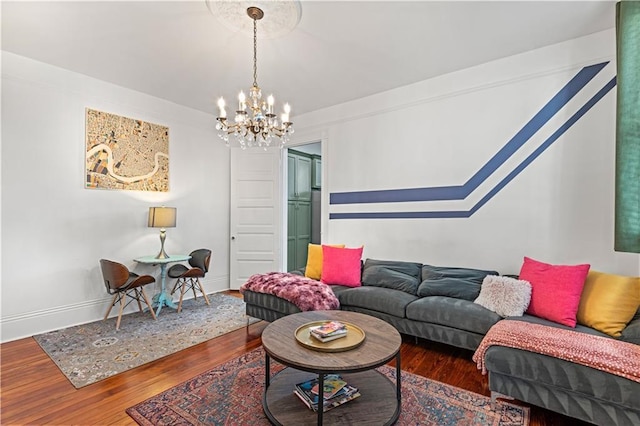 living room with a notable chandelier and dark wood-type flooring