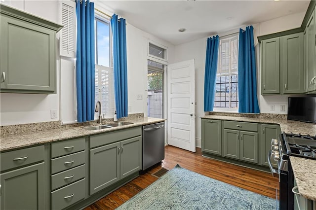 kitchen featuring sink, stainless steel appliances, plenty of natural light, and green cabinetry