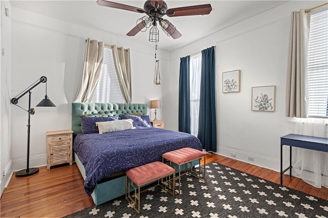 bedroom with wood-type flooring and ceiling fan