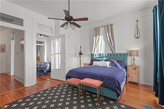 bedroom with hardwood / wood-style floors and ceiling fan