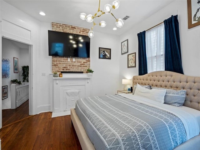 bedroom with dark hardwood / wood-style flooring and a chandelier