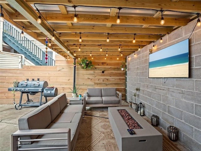 view of patio with area for grilling and an outdoor living space with a fire pit