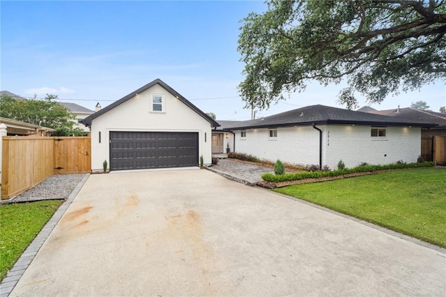 single story home featuring a garage and a front lawn