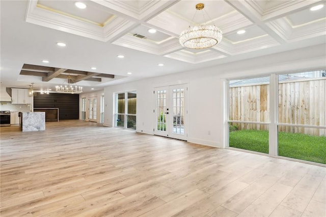 unfurnished living room with french doors, ornamental molding, beamed ceiling, a notable chandelier, and light hardwood / wood-style floors