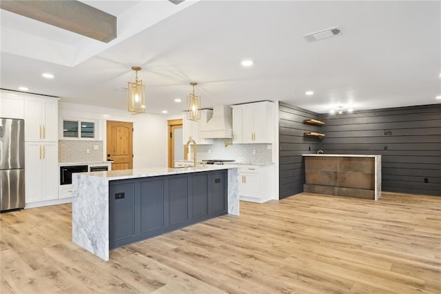 2914 Ridgeway Dr, Metairie, LA 70002 - kitchen featuring stainless steel appliances, premium range hood, white cabinets, backsplash, and recessed lighting