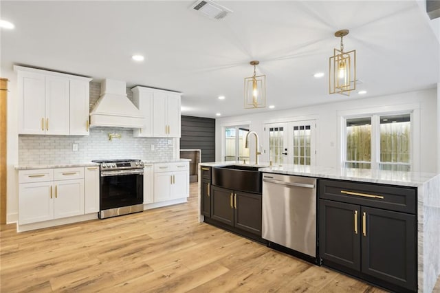 2914 Ridgeway Dr, Metairie, LA 70002 - kitchen with appliances with stainless steel finishes, custom exhaust hood, white cabinetry, and recessed lighting