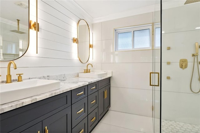 bathroom with tile patterned flooring, crown molding, an enclosed shower, vanity, and tile walls