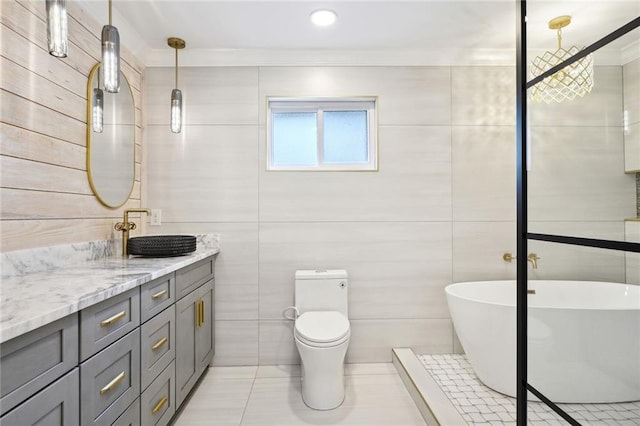 2914 Ridgeway Dr, Metairie, LA 70002 - bathroom featuring vanity, a soaking tub, tile patterned flooring, ornamental molding, and tile walls