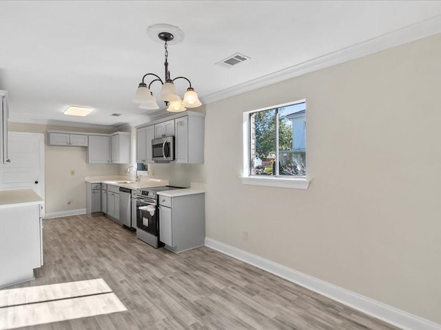 kitchen featuring light wood-type flooring, ornamental molding, stainless steel appliances, a notable chandelier, and gray cabinets