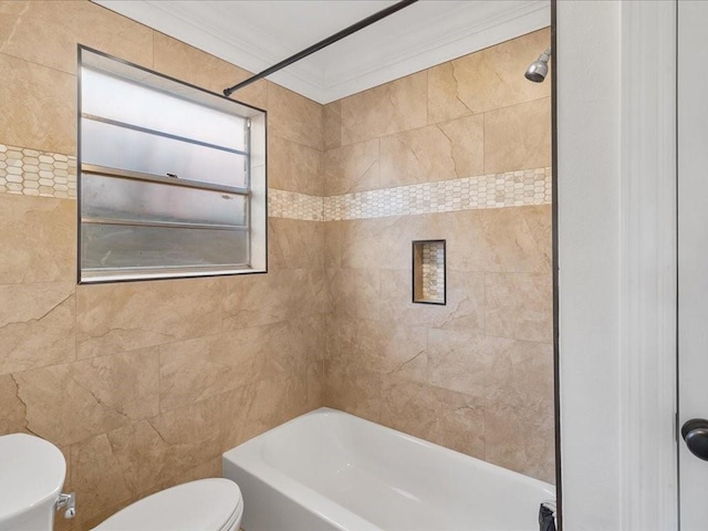 bathroom featuring ornamental molding, tiled shower / bath combo, and toilet