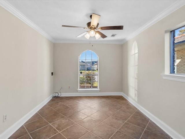 spare room with dark tile patterned flooring, ceiling fan, and ornamental molding