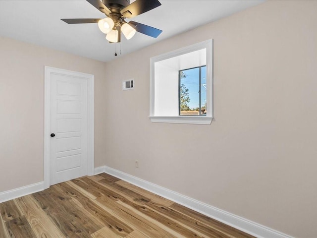 empty room featuring wood-type flooring and ceiling fan