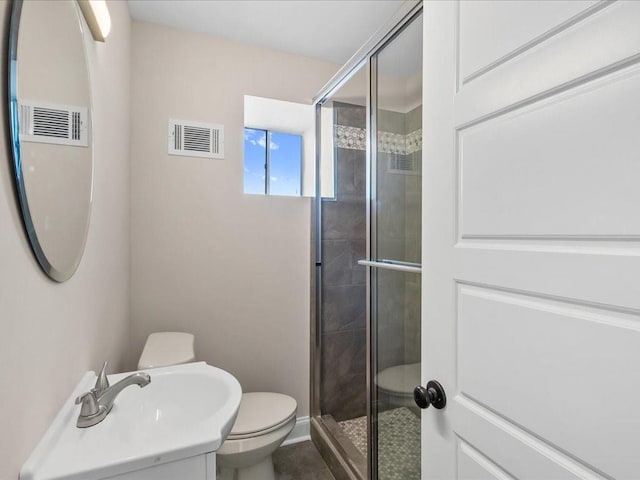 bathroom with vanity, an enclosed shower, and toilet