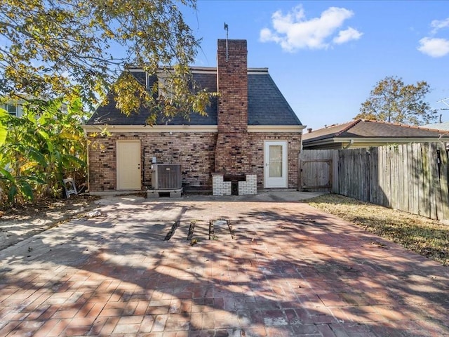 rear view of property featuring a patio area and central air condition unit