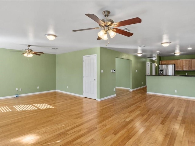 unfurnished living room with light wood-type flooring and ceiling fan